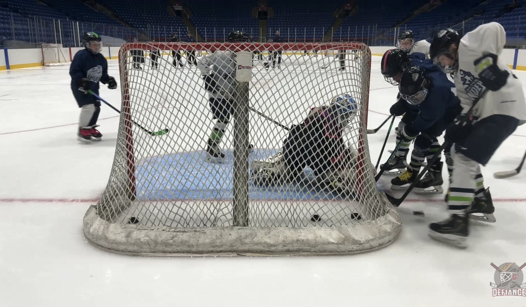 Goalie action captured from behind the net
